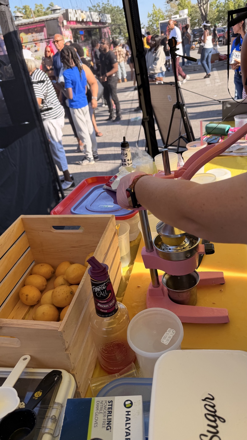 Fresh lemons being prepared by hand at The Lemon Aid Lounge booth